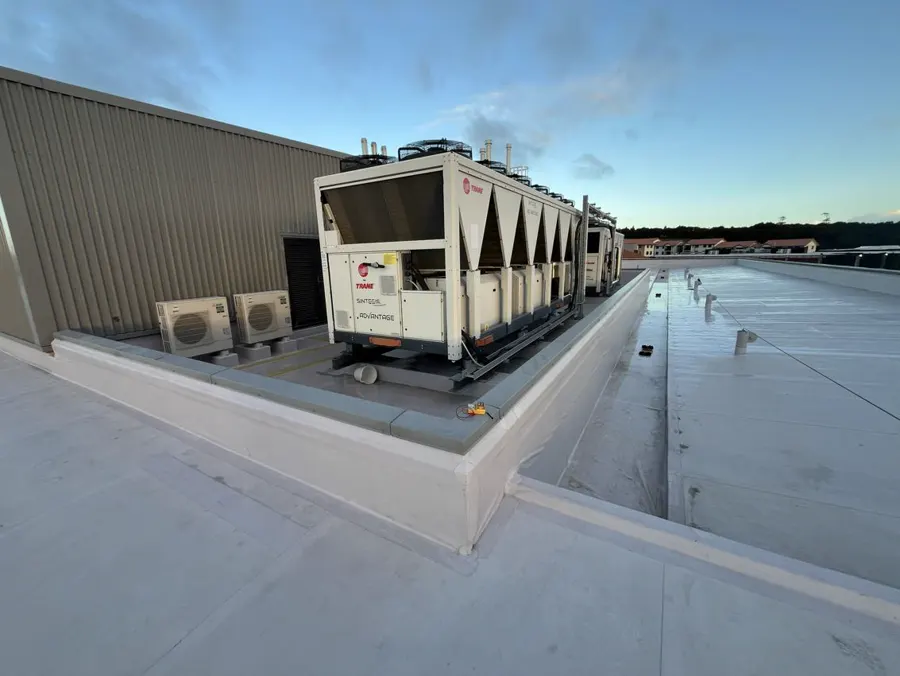 Membrane upstands around a rooftop plant platform, with junctions, changes in level and pipe penetrations