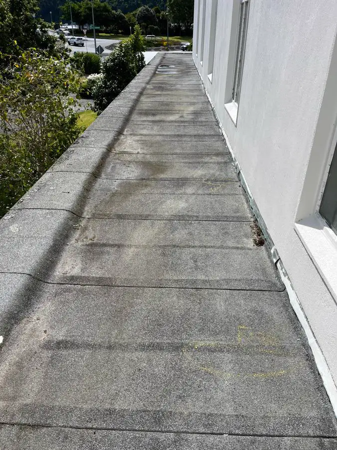 Ageing torch-on membrane roof with leak locations marked in yellow