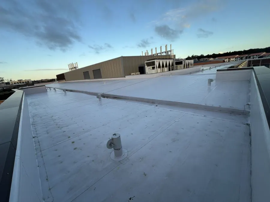 Single-ply membrane roof on an Auckland university building, with plant and pipe supports